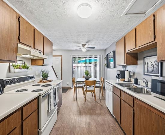 A kitchen with wooden cabinets and a white countertop.